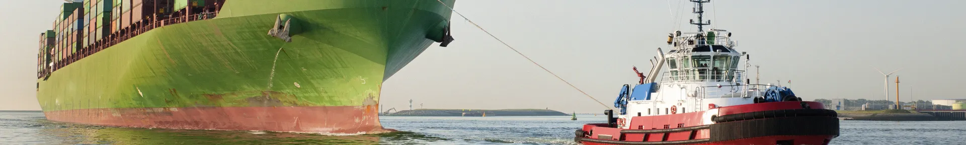 Tug pulling a cargo ship